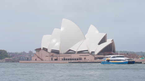 timelapse of famous landmark sydney opera house building timelapse across harbor with boats and ferries passing, 4k australia