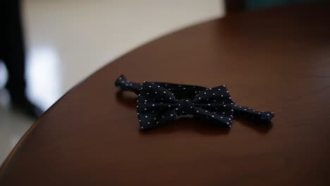 black bow tie on a wooden table