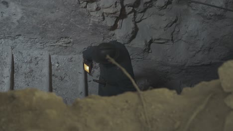 soldier walking on bunker stair with lamp in hand and keep watching with deep focus