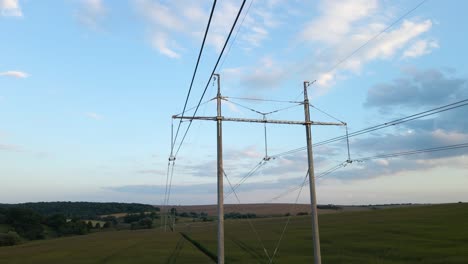 tower with electric power lines for transfering high voltage electricity located in agricultural cornfield. delivery of electrical energy concept