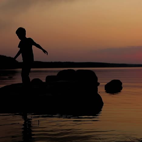 boy playing on stone
