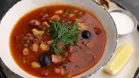 solyanka soup with toasts and lemon