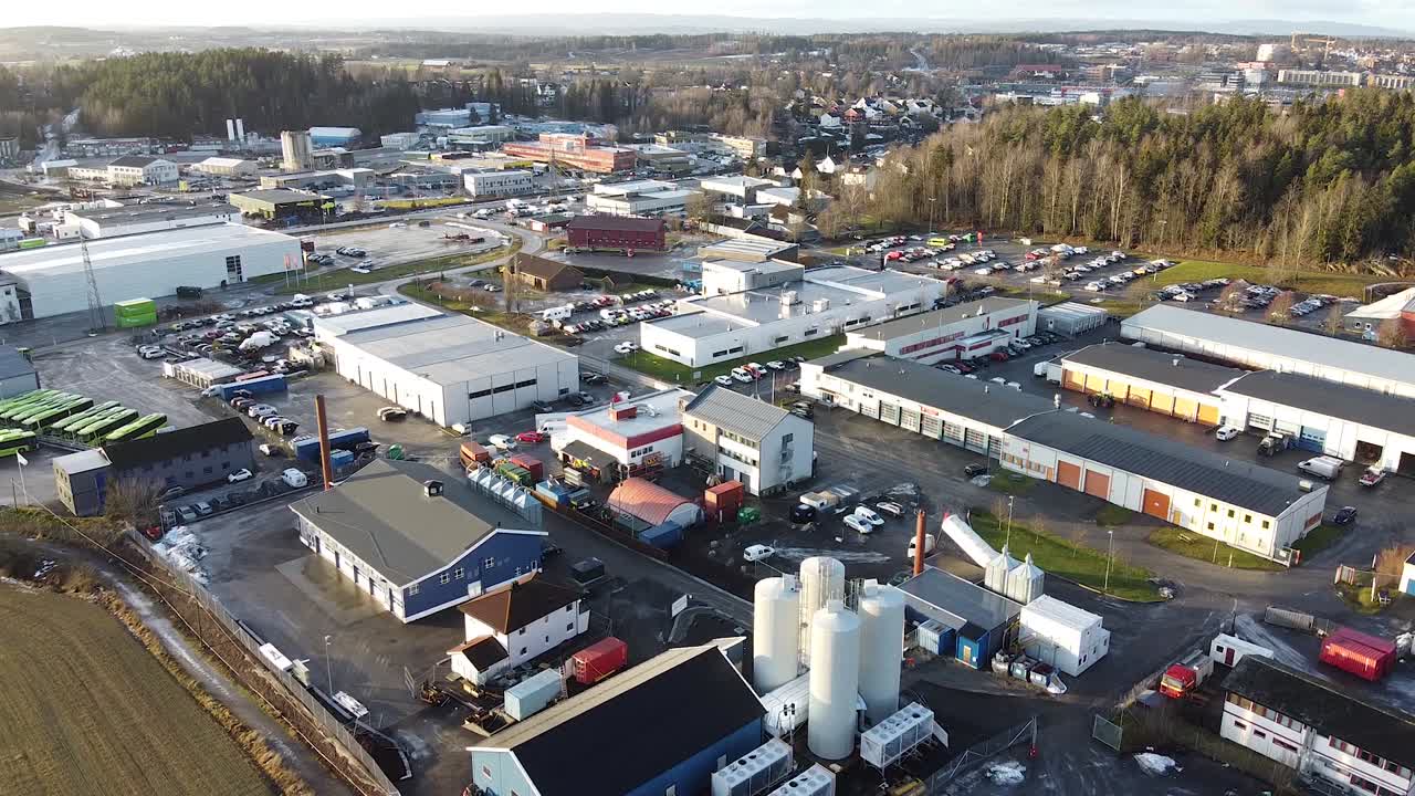 Drone flight over the business industrial center of a small town near a pine forest