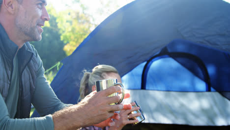 Family-having-coffee-outside-the-tent