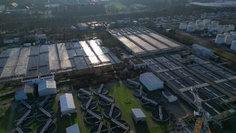 wastewater treatment plant purifying urban water showing sedimentation tanks, aeration tanks and clarifiers. fabulous aerial view flight