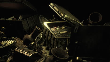 curious treasures scattered across a dark surface in a mysterious setting
