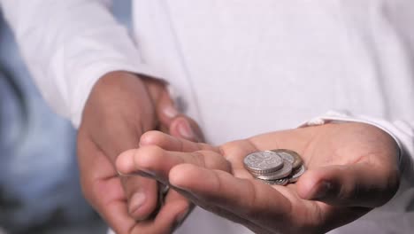 person holding coins in their hands