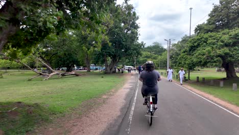 group of tourists is enjoying a bicycle ride through the lush green landscapes of anuradhapura, a unesco world heritage city in sri lanka