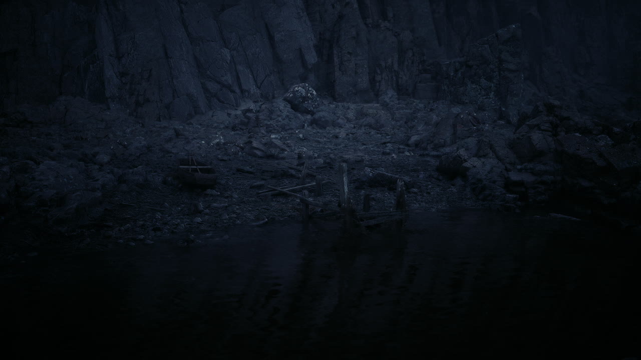 Dark rocky shoreline with still water during twilight