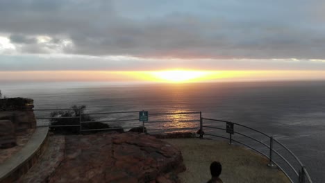 man walking into sunset in chapman's peak, cape town