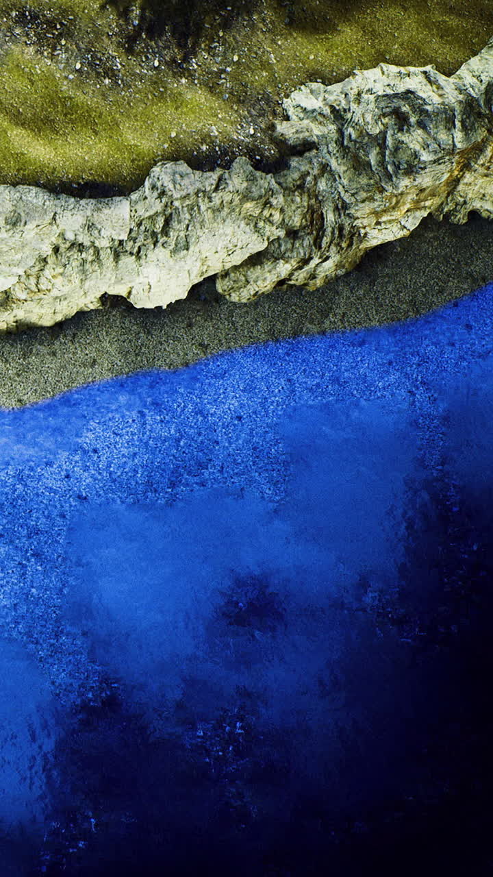 Coastal scene with water sand and rocky shoreline during daylight hours