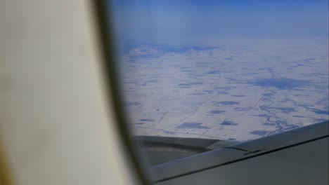 Aircraft-wing-and-picturesque-mountain-landscape-from-high-level-from-airplane-window