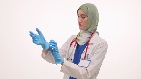female doctor putting on medical gloves