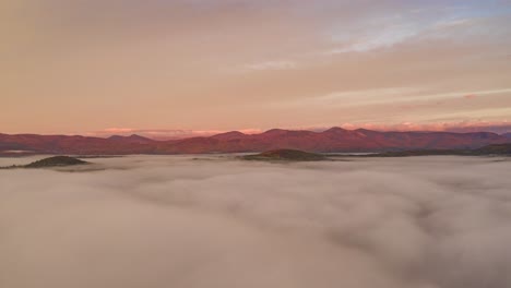 Timelapse-of-the-sunrise-on-the-White-Mountains-over-the-clouds-AERIAL-STATIONARY