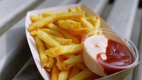 Close-up-to-freshly-served-fast-food---french-fries-with-tomato-and-mayo-sauce