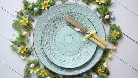 easter table setting with flowers and eggs  empty decorative ceramic plates