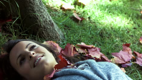 brunette lying on grass in slow motion