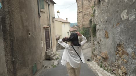 Woman-walking-in-french-village