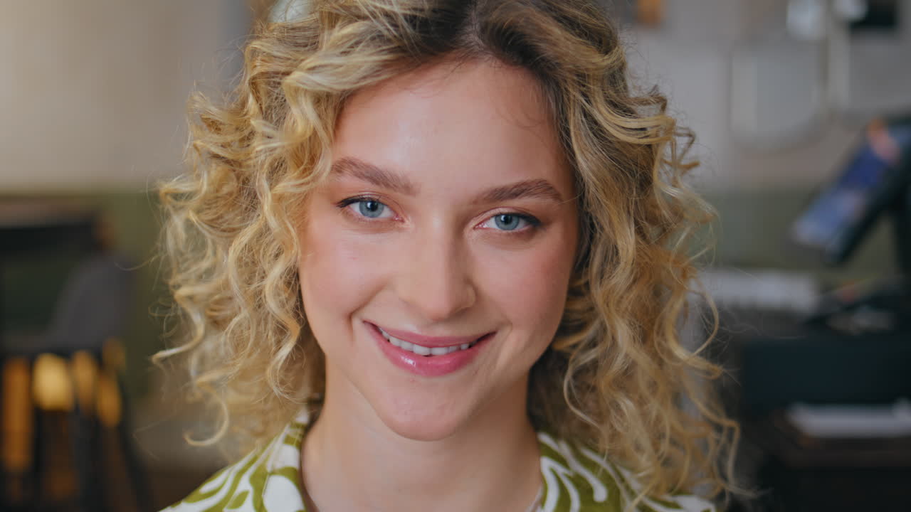 Portrait attractive blonde woman looking camera with gentle smile. Positive lady