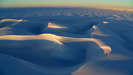 aerial view of vast desert sand dunes at golden hour