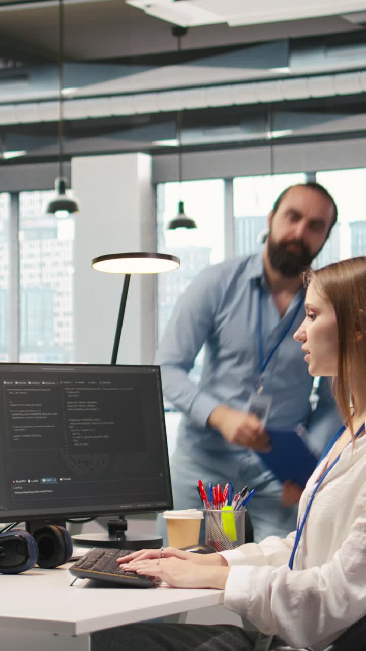 Vertical video Friendly coworkers helping junior dev code AI algorithms to debug software