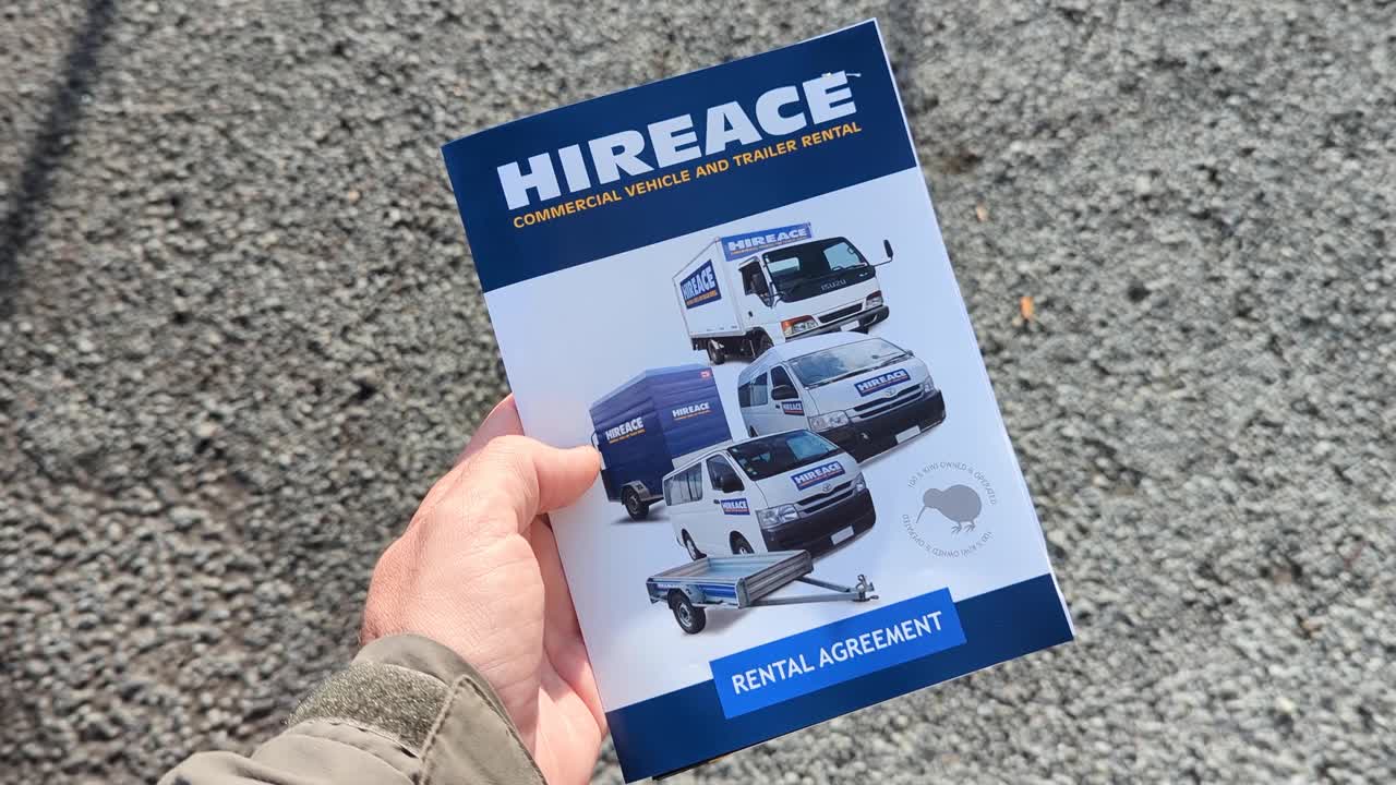 Hand holding a Hireace commercial vehicle and trailer rental brochure