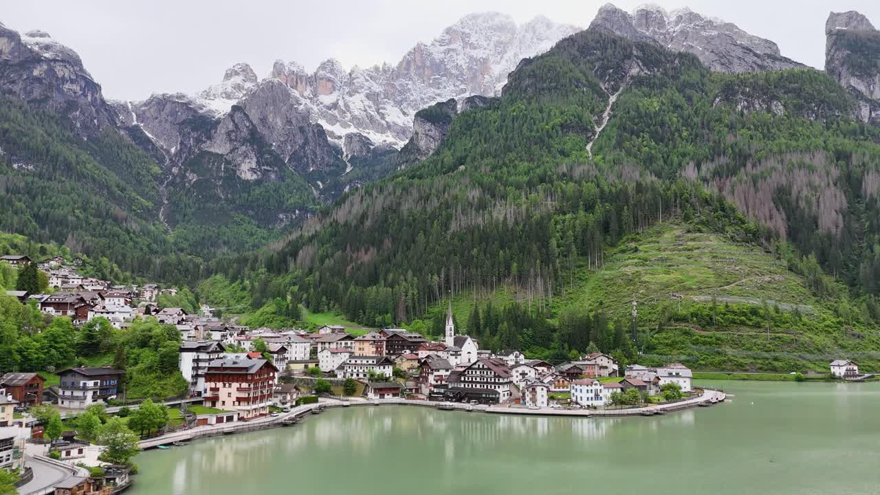 Drone cinematic video reveal Alleghe village with lake and Dolomite peaks