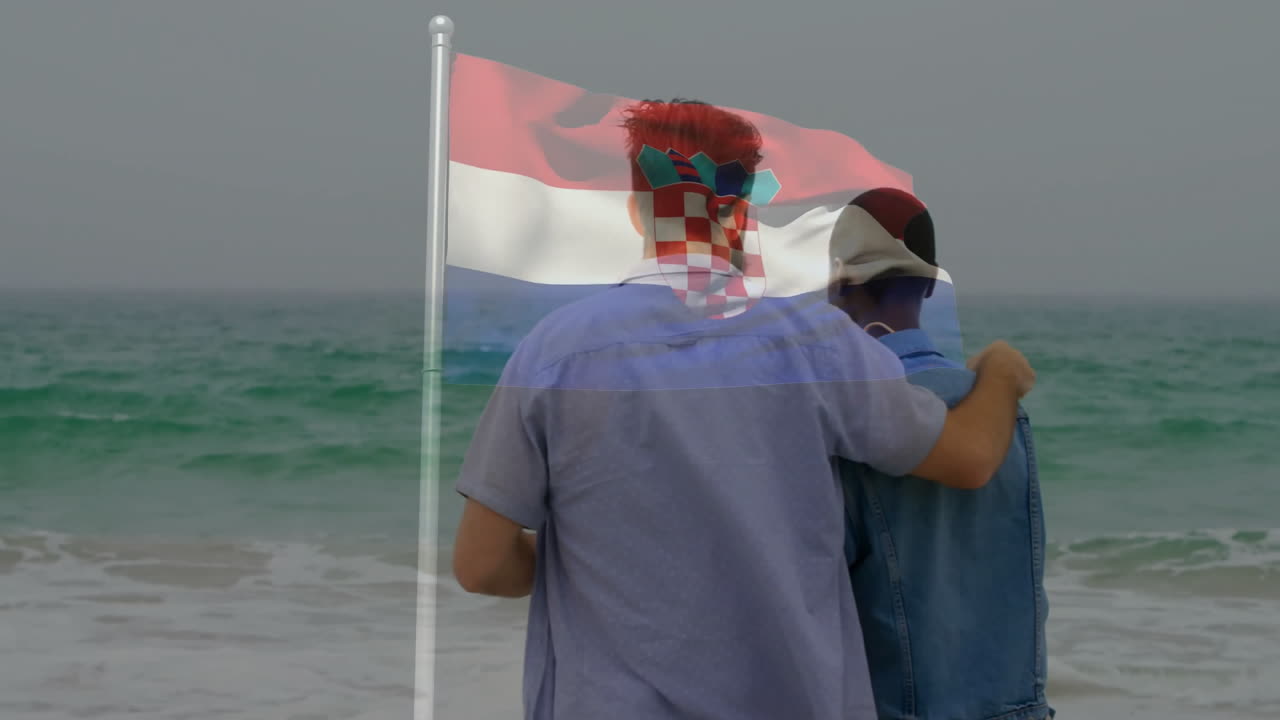 Standing on beach, two people with Croatian flag animation overlay, smiling together