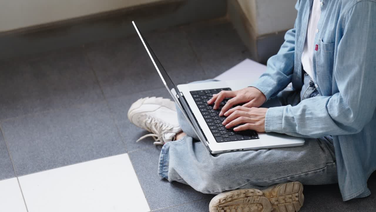 Two Asian girls student partners are working on a laptop help study together