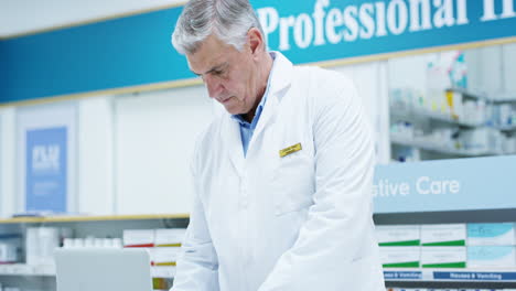 a handsome senior male pharmacist working