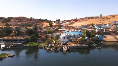 aerial of the nubian village on the nile river , traditional egyptian sailing boats, in aswan, egypt, embodying the concept of timeless maritime heritage and cultural richness