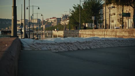 row of sandbags lines the riverbank protecting city during ongoing budapest flood of 2024