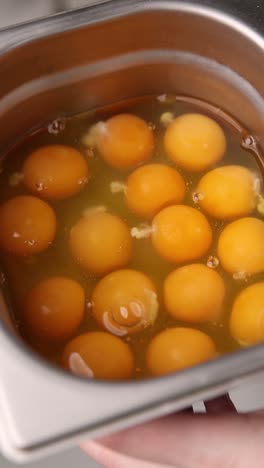 separated eggs in a metal bowl