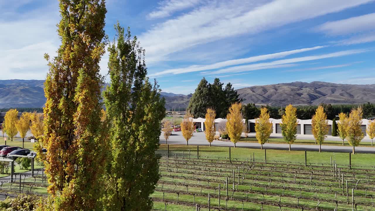 A serene autumn landscape with vibrant foliage and distant mountains under a clear sky, captured at Highlands Motorsport Park