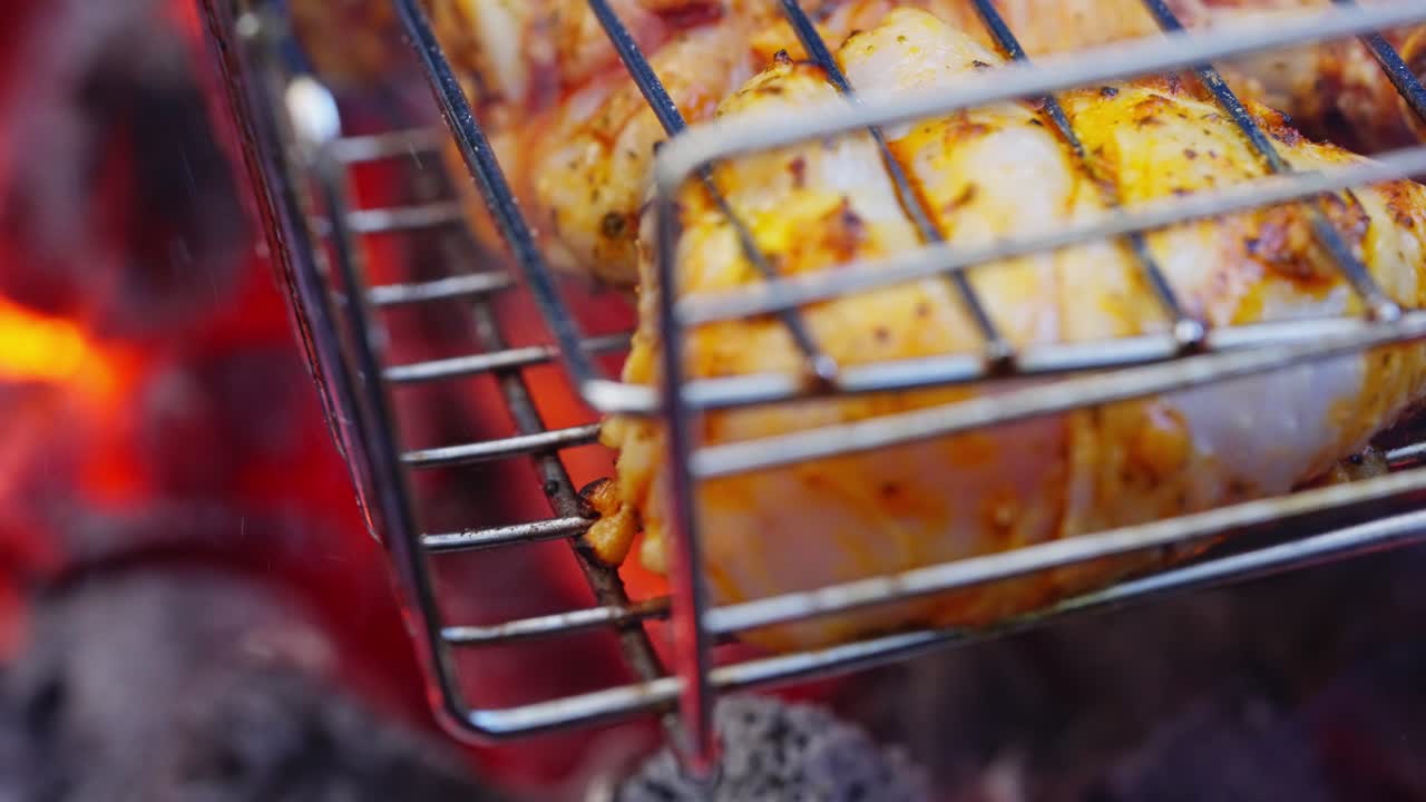 Meat and vegetables grilling on hot coals with rising flames during backyard barbecue, macro detailed abstract flames