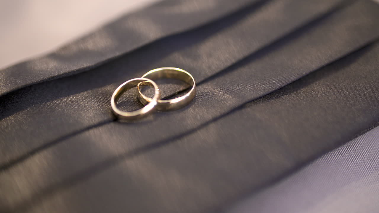 Golden Wedding Rings on Black Background