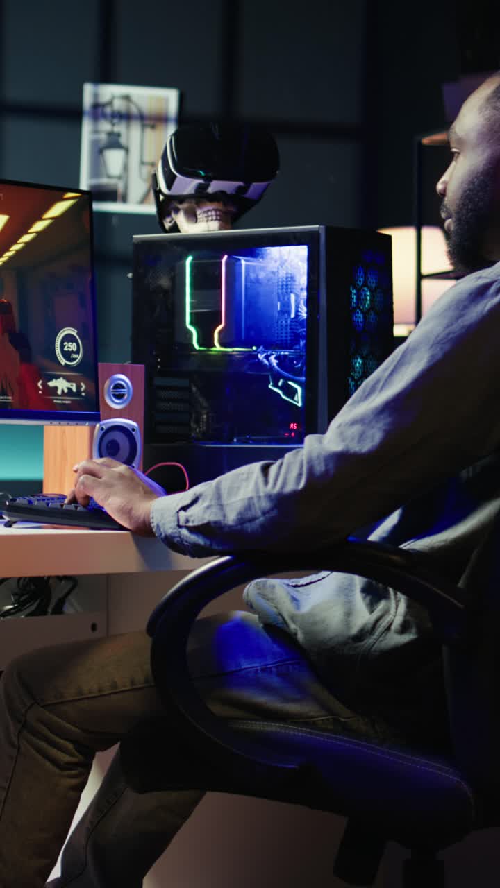 Vertical video Man arriving at home to play videogames on gaming PC at computer desk