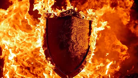 a fire with a shield on fire in the middle of it