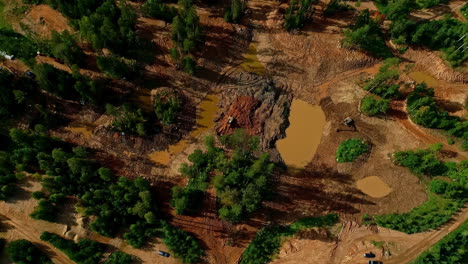 an aerial shot of a forest landscape with mud traces and breccia sediments