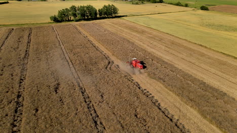 combine harvester gathers the wheat crop during beautiful sunny day,aerial view