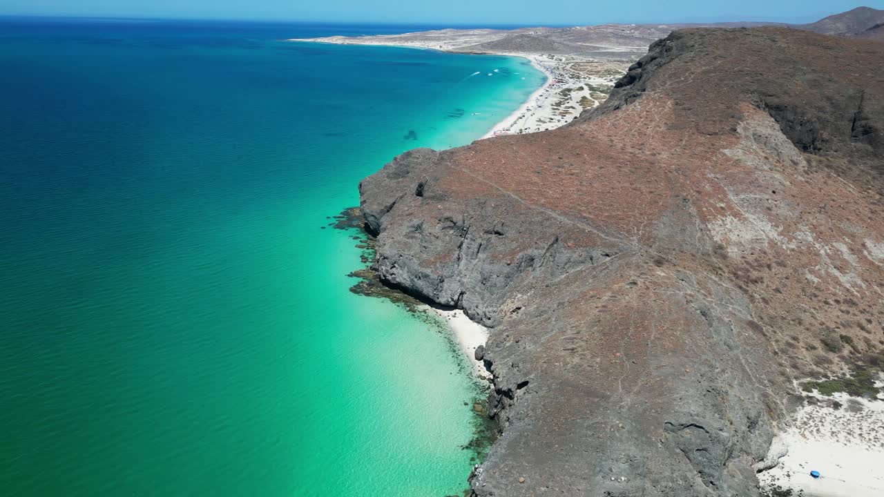 Crystal-clear waters along a rocky beach with stunning coastal views in La Paz, Mexico