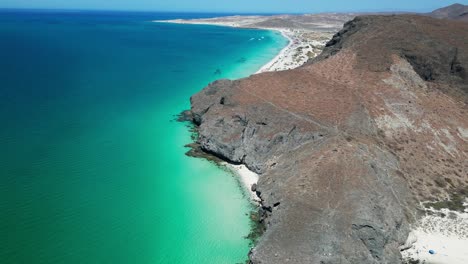Crystal-clear waters along a rocky beach with stunning coastal views in La Paz, Mexico