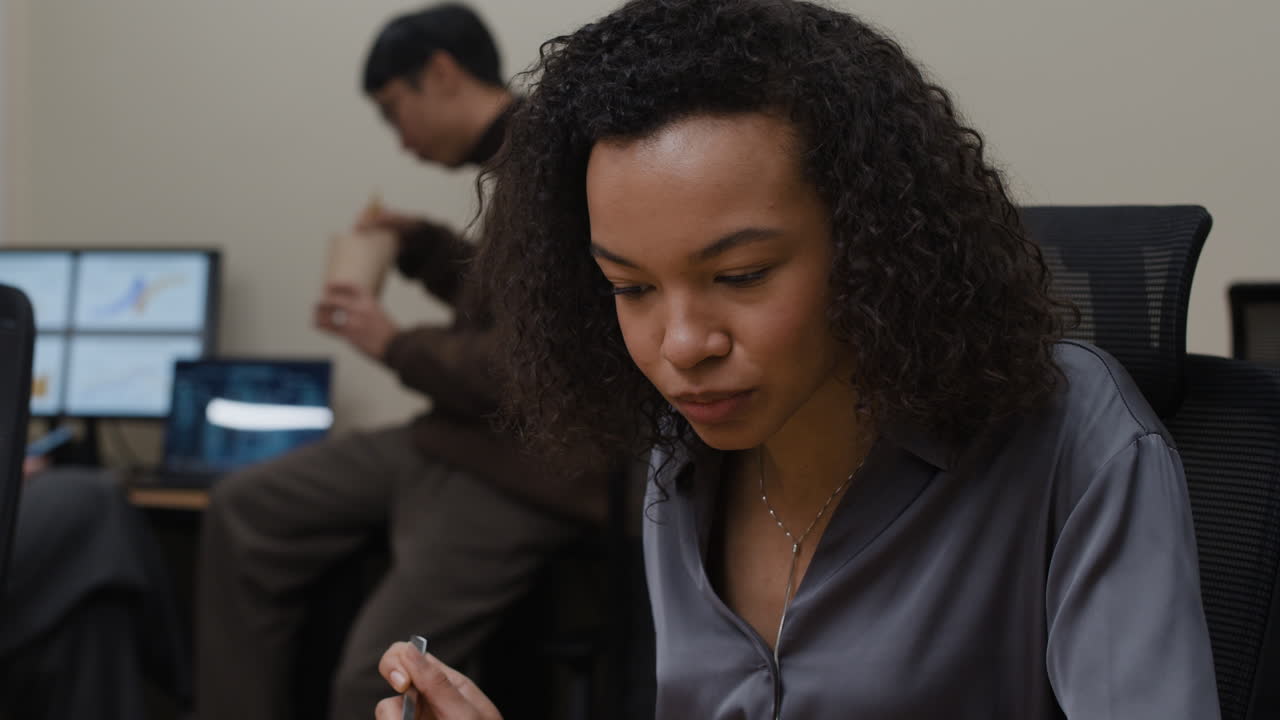Woman eating in office