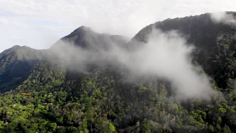 clouds over valle de anton volcanic crater walls in central panama extinct volcano, aerial pan right shot