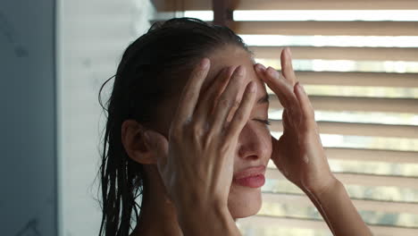 woman washing her face in the shower