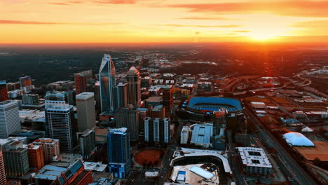 orange light spreading above the cityscape of a modern city. scenic view of charlotte, north carolina, usa at sunset. top perspective