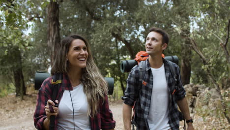 excited couple of hikers looking around, admiring landscape