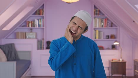 sick muslim man suffering from tooth pain