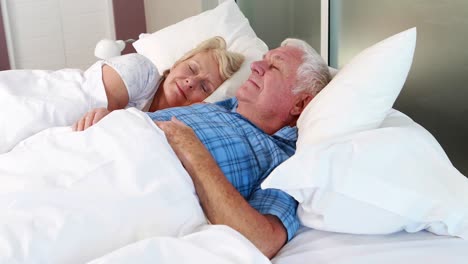 senior couple sleeping in bed