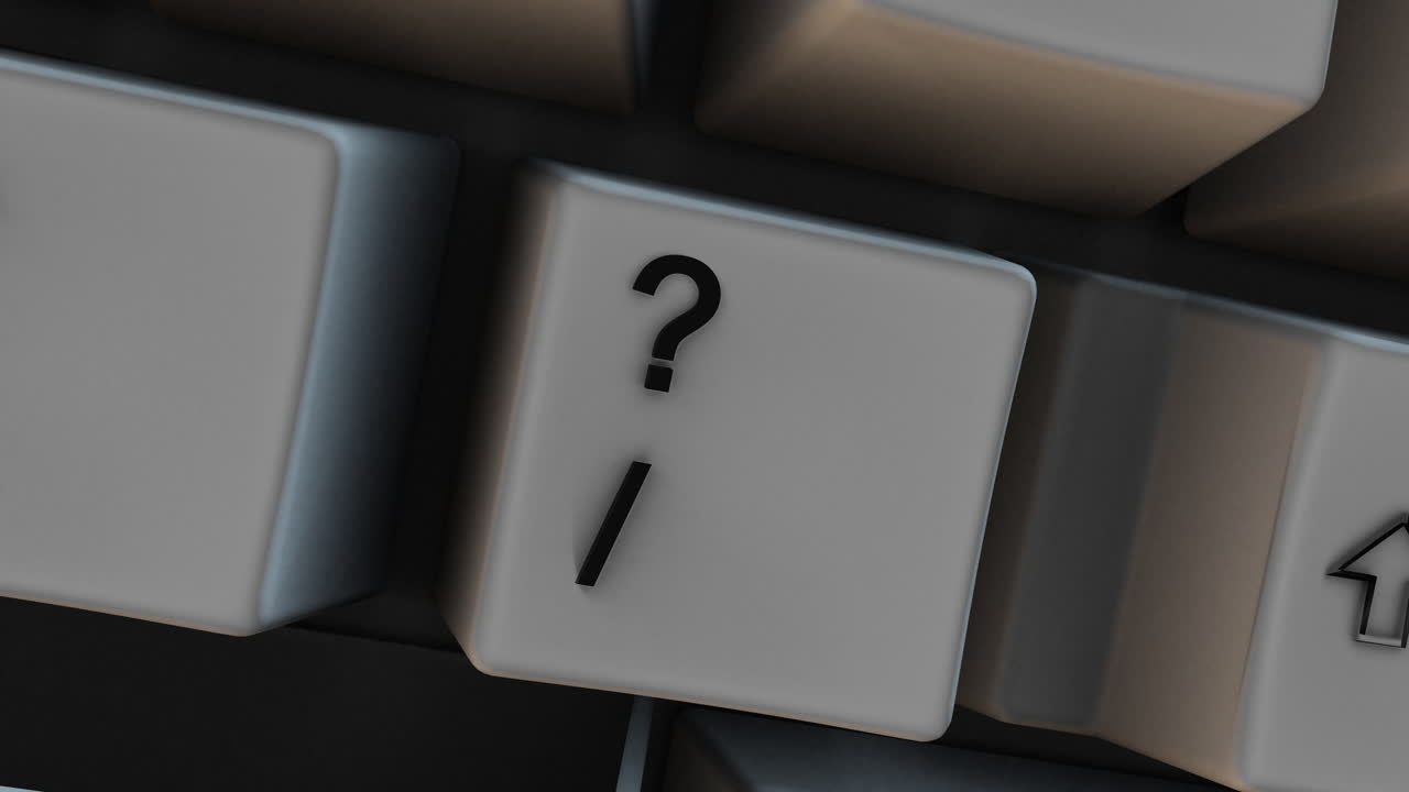 Close-up of ? Question Mark Key on Computer Keyboard with Forward Slash Sign. Great for business presentations, online education, and workplace productivity videos